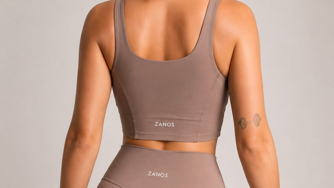 Woman wearing stylish yoga leggings and crop top showcasing best yoga leggings for women in a neutral color.