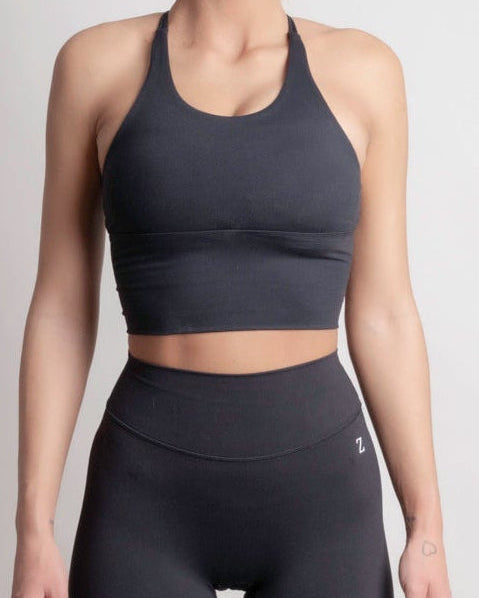 Front view of woman wearing Zanos Drop 01 NOIR sculpt sport top and leggings by ZANOS Apparel