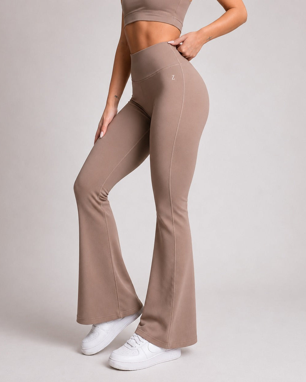 Front view of woman wearing brown NOIR sculpting leggings by ZANOS Apparel Sale Div
