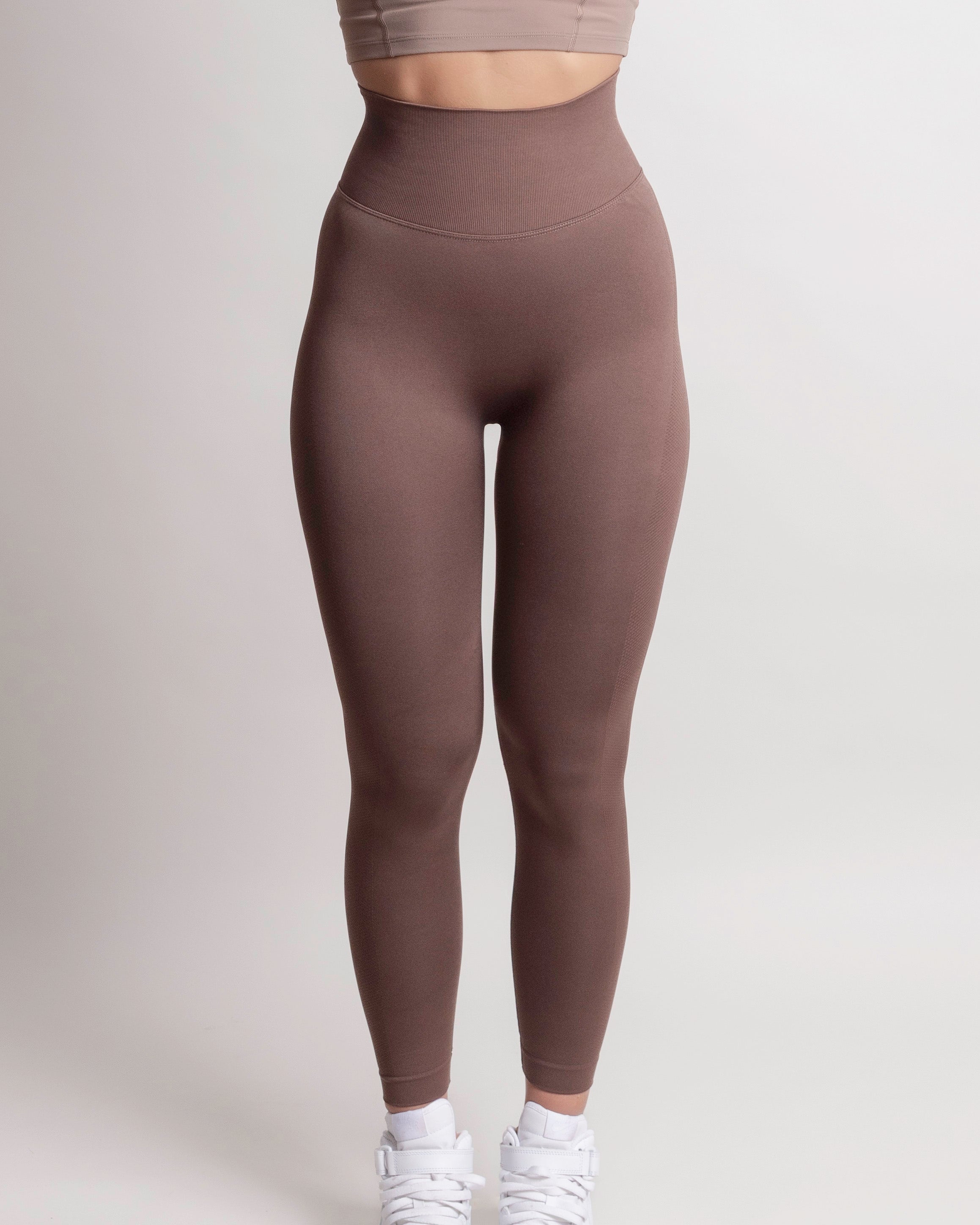 Front view of woman wearing brown NOIR sculpting leggings by ZANOS Apparel Sale Div