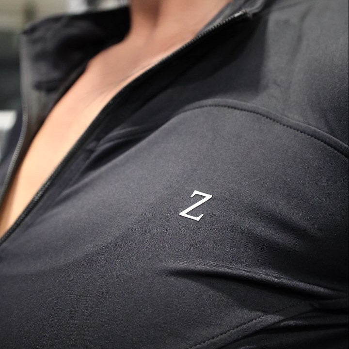Close-up of a dark gray sleeve with a logo on a blurred background