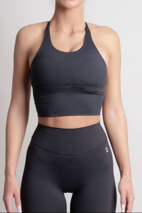 Front view of woman wearing Zanos Drop 01 NOIR sculpt sport top and leggings by ZANOS Apparel