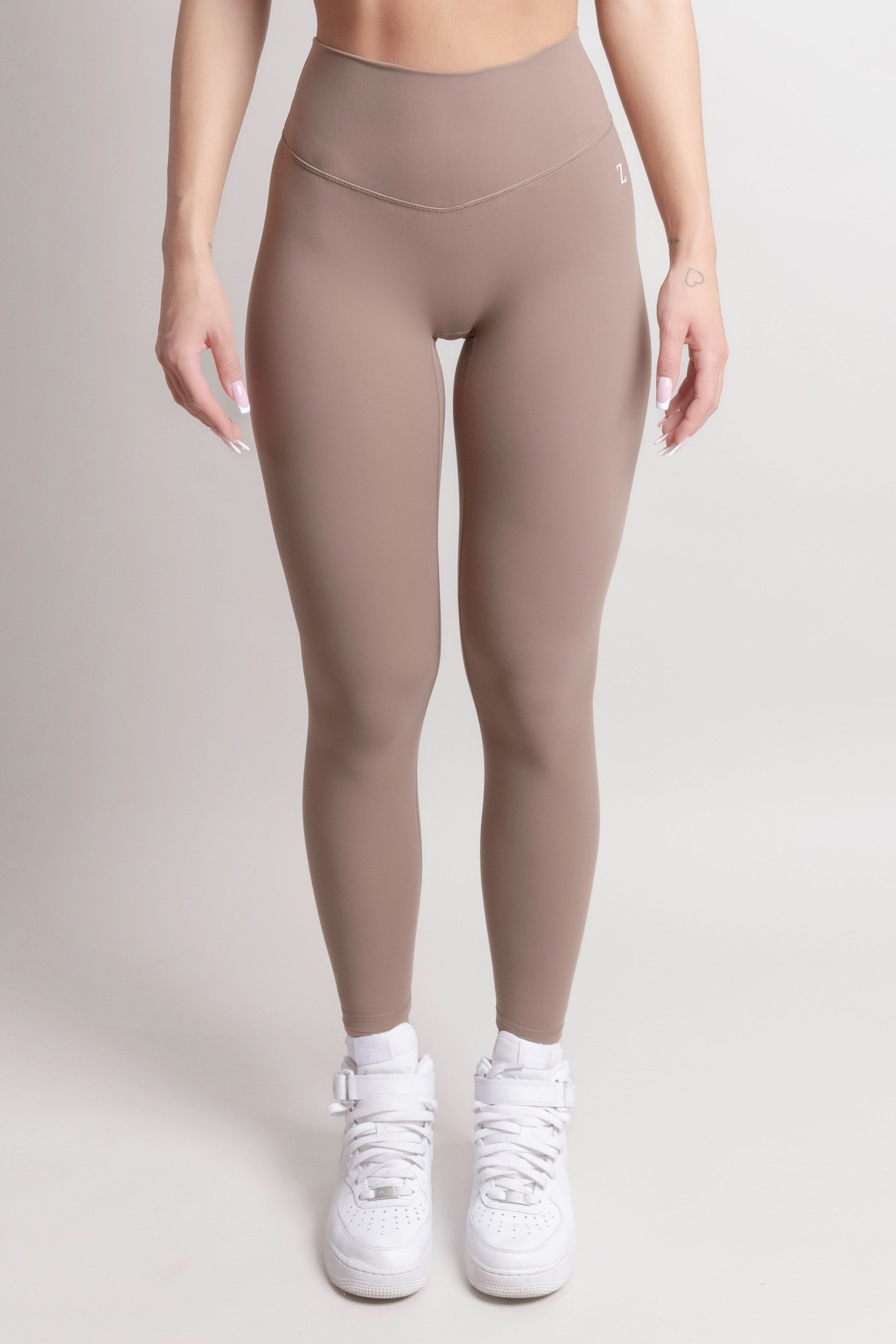 Woman wearing black NOIR Sculpt leggings by ZANOS Apparel