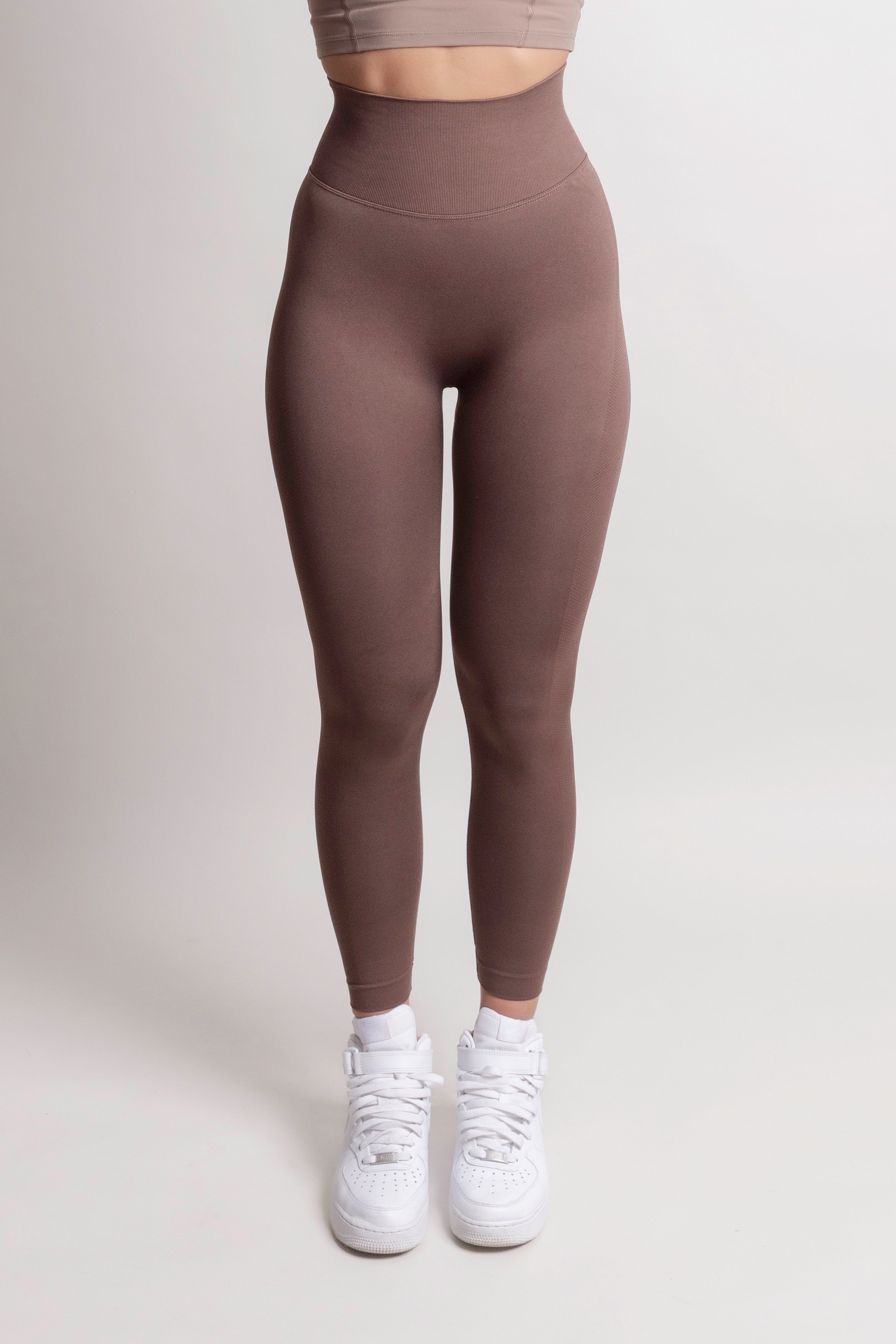 Front view of woman wearing brown NOIR sculpting leggings by ZANOS Apparel Sale Div